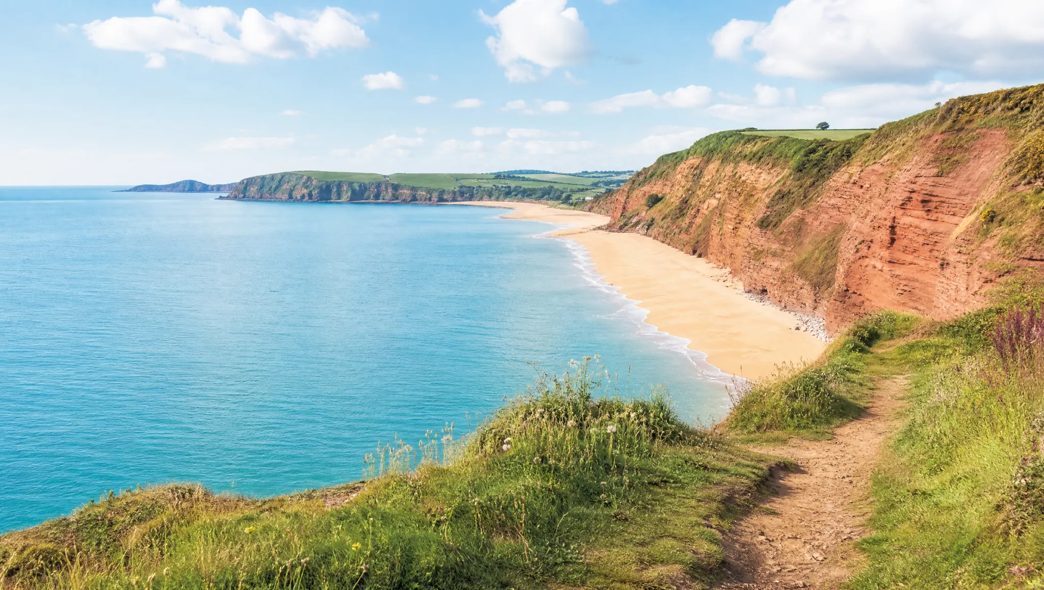 Red sandstone cliffs and a sandy beach on the East Devon coast